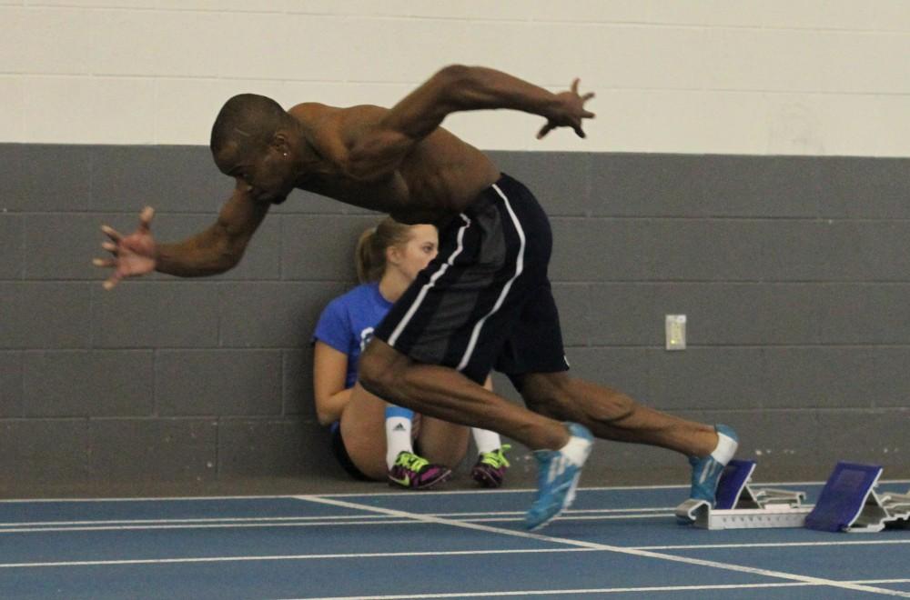 Sean Wells takes off to gain speed for jumping hurtles while at track practice on Feb. 4 in Allendale, MI. 