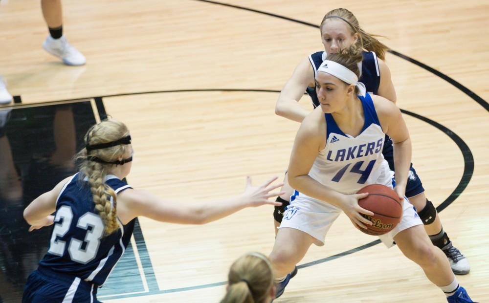 GVL / Kevin Sielaff - Taylor Parmley (14) receives an inbound pass and looks to post up.  The Lakers defeat the Chargers of Hillsdale College Saturday, Jan. 30, 2016 in Allendale.
