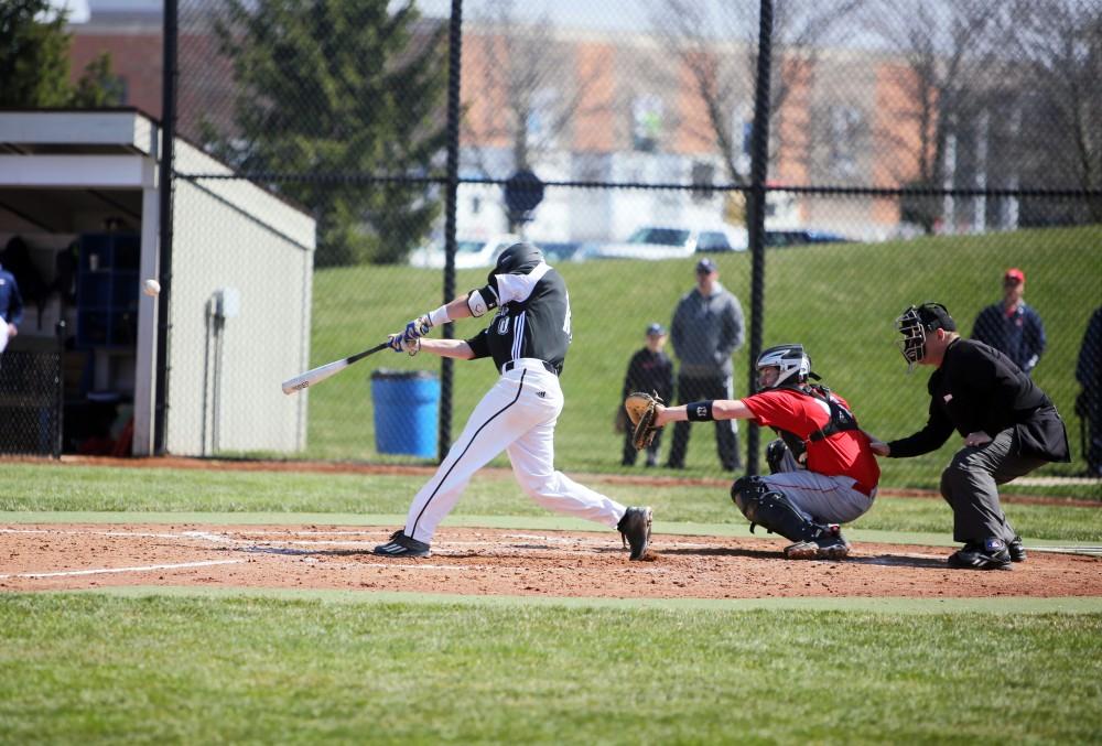 GVL / Emily Frye 
Connor Glik drives the ball to the outfield against Saginaw Valley State University on Saturday Mar. 26, 2016. 