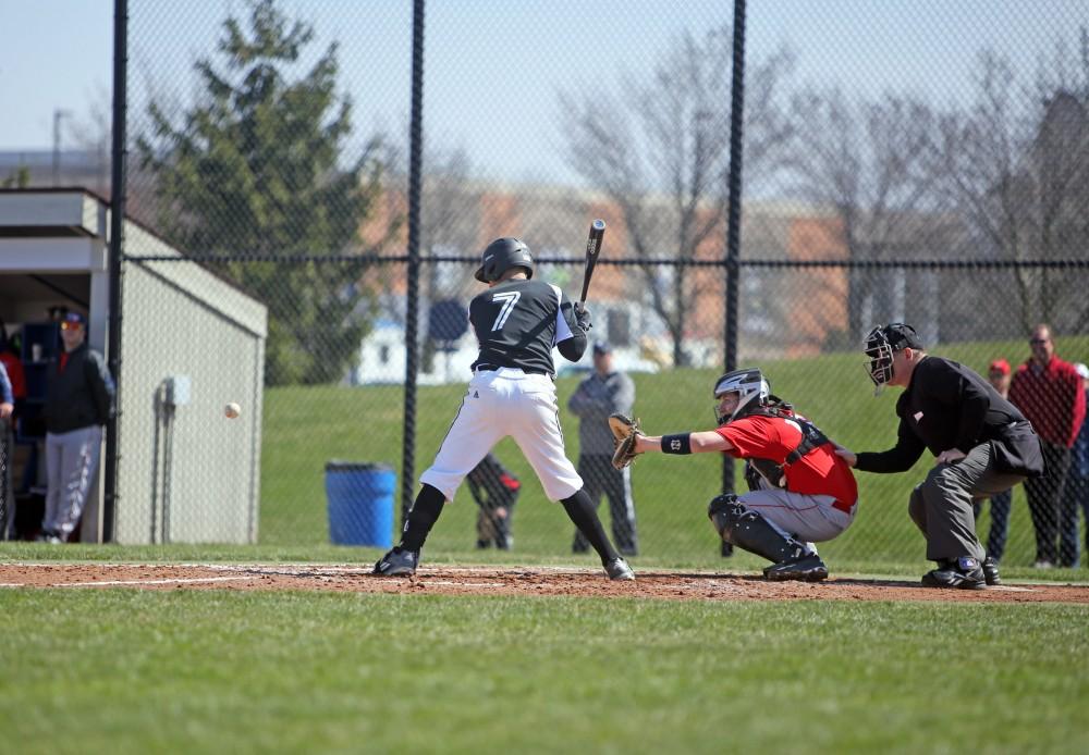 Junior Matt Williams watches the ball coming towards the plate against Saginaw Valley State University on Saturday Mar. 26, 2016. 