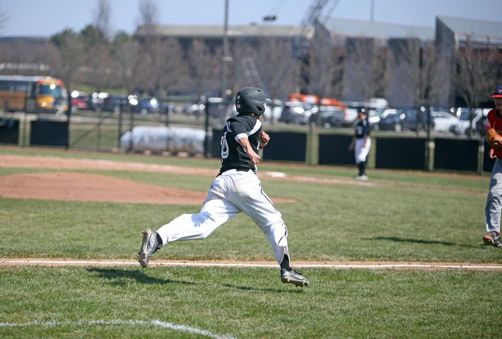 GVL / Emily Frye 
Infielder Johnny Nate sprints towards home against Saginaw Valley State University on Saturday Mar. 26, 2016. 