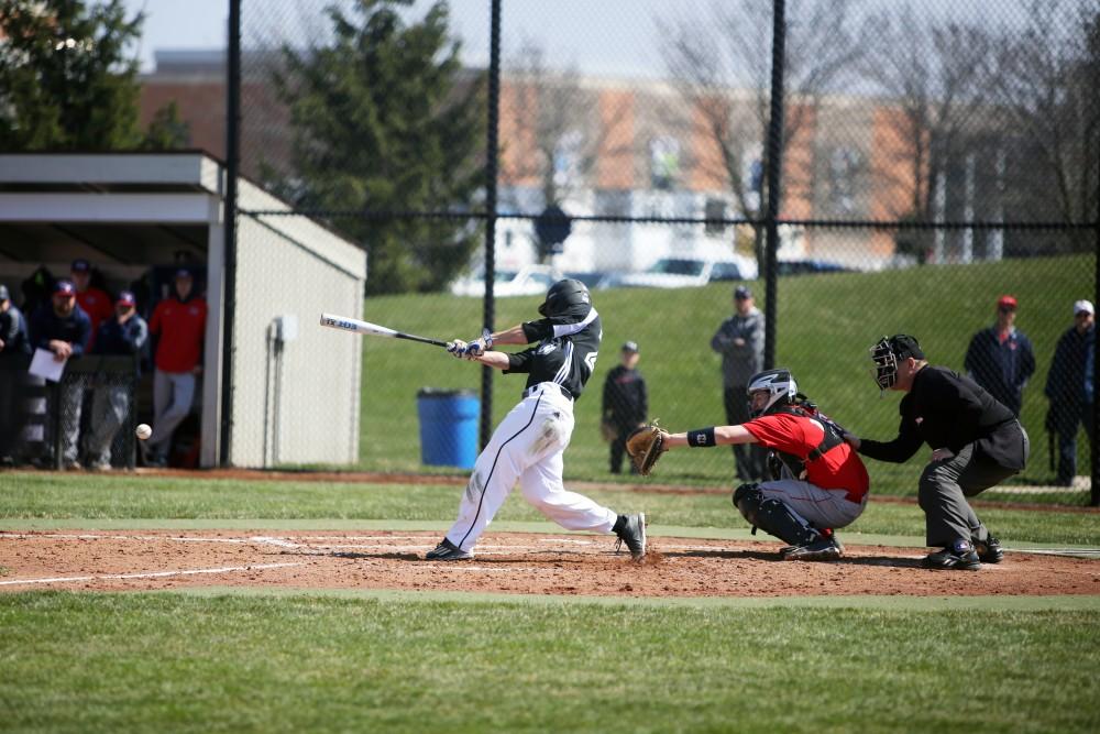 GVL / Emily Frye   
Junior Keith Browning makes a soild hit against Saginaw Valley State University on Saturday Mar. 26, 2016.