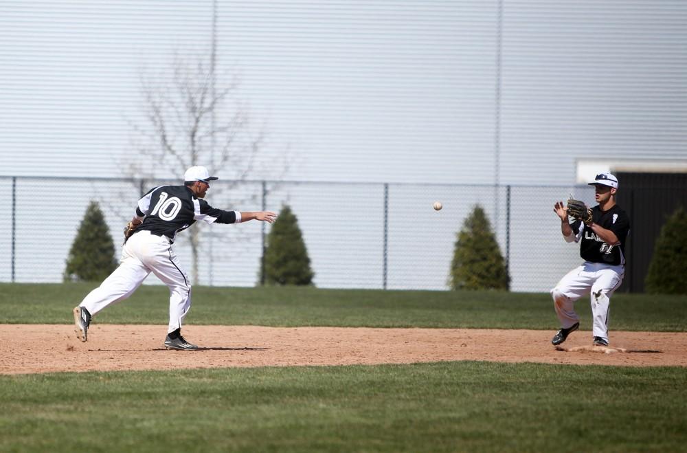 GVL / Emily Frye   
Junior Johnny Nate gets the ball to Josh Smith to make the out at second against Saginaw Valley State University on Saturday Mar. 26, 2016.