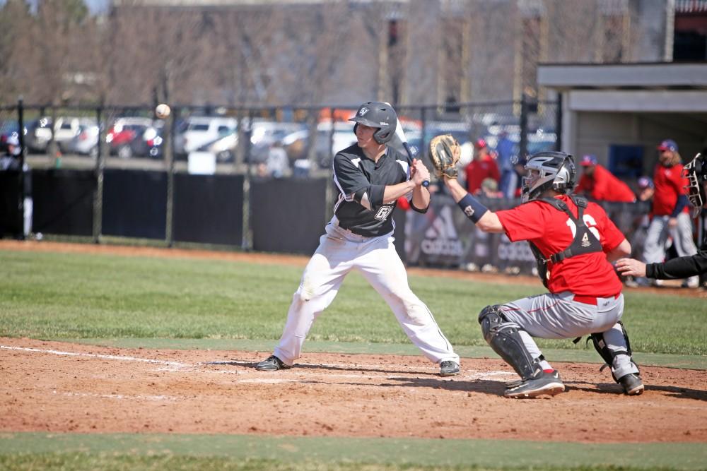 GVL / Emily Frye   
Junior Keith Browning keeps his eye on the ball against Saginaw Valley State University on Saturday Mar. 26, 2016.