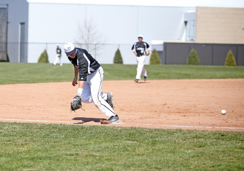 GVL / Emily Frye   
Infielder Anthony Villar stops the ball against Saginaw Valley State University on Saturday Mar. 26, 2016.