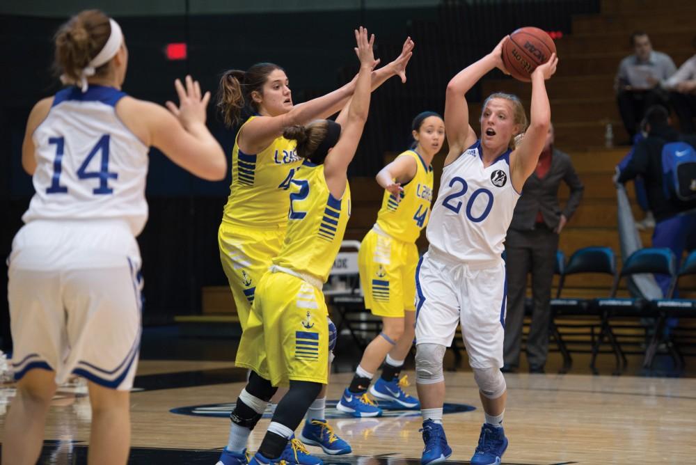 GVL / Luke Holmes - 
Janae Langs (20) attempts to get rid of the ball with her defenders are approaching. Grand Valley had a victory over Lake Superior State Thursday, Feb. 12, 2016.