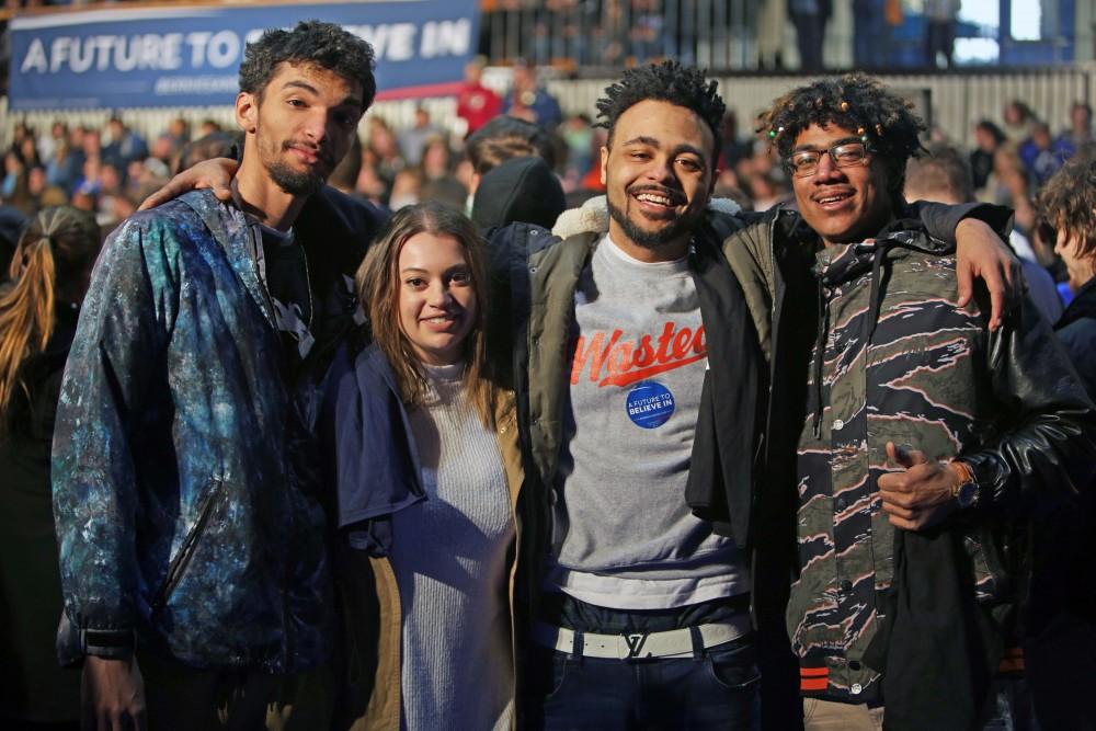 GVL / Emily Frye 
(From left to right) Jordan Harris, Amy Myers, Devon Watson, and Dakota Rivera excitedly await Bernie Sanders arrival on Friday Mar. 4, 2016. 