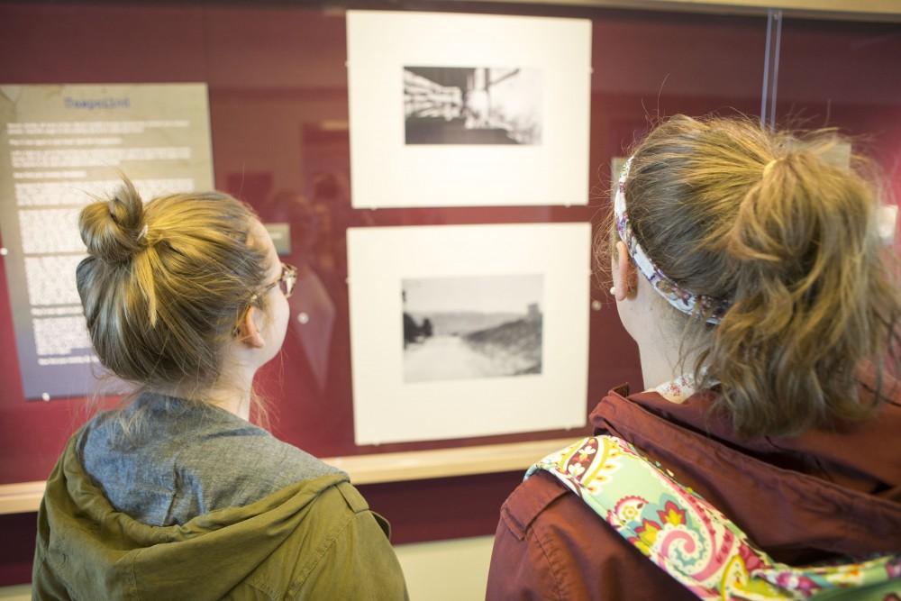 GVL / Sara Carte - Grand Valley students, (left to right) Alison Farnsworth and Brittany Patrosso, look at the Flashladder Gallery Exhibit in Lake Ontario hall on Friday, March 18, 2016.