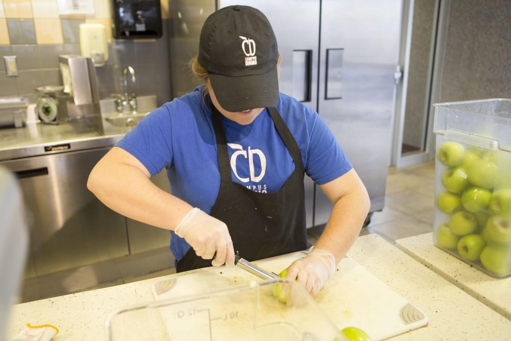 GVL / Sara Carte - Campus dining worker, Nicole Buchmann, cores apples in Fresh on Monday, Mar. 28, 2016.