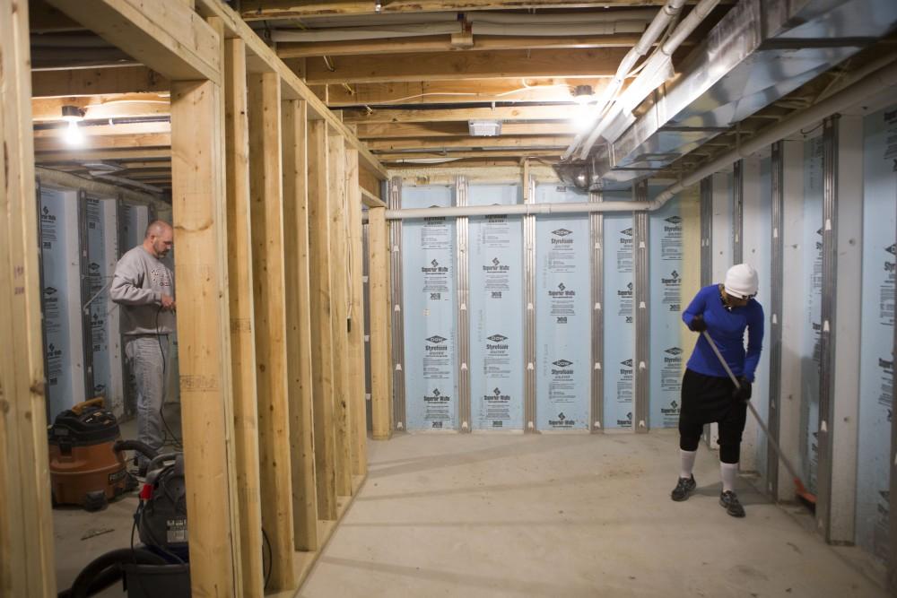 GVL / Sara Carte - Grand Valley alumni, Steve Peterson (left) and LaToya Floyd (right), volunteer for Kent County Habitat for Humanity in Grand Rapids on Thursday, Mar. 24, 2016.