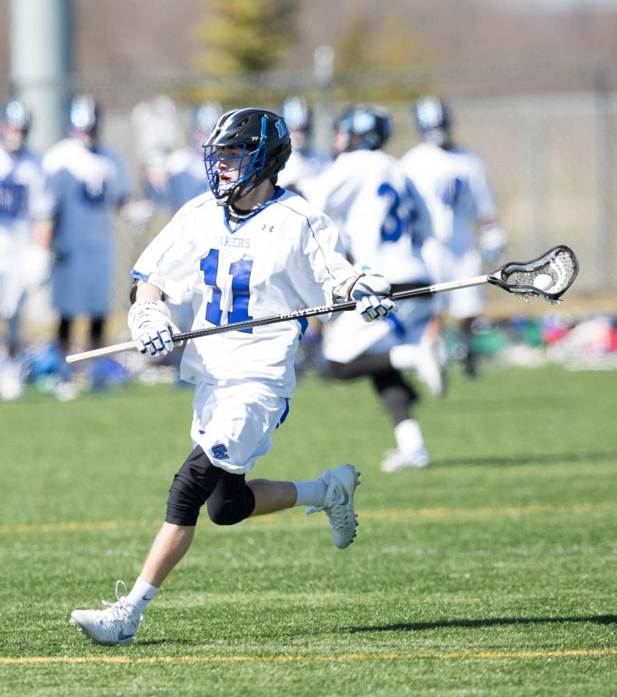 GVL / Kevin Sielaff – Peter Treppa (11) moves into Siena's zone. Grand Valley’s men’s lacrosse team squares off against Siena Heights University Sunday, March 20, 2016 in Allendale.