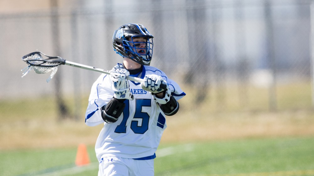 GVL / Kevin Sielaff – Jake Parry (15) passes the ball up field. Grand Valley’s men’s lacrosse team squares off against Siena Heights University Sunday, March 20, 2016 in Allendale.