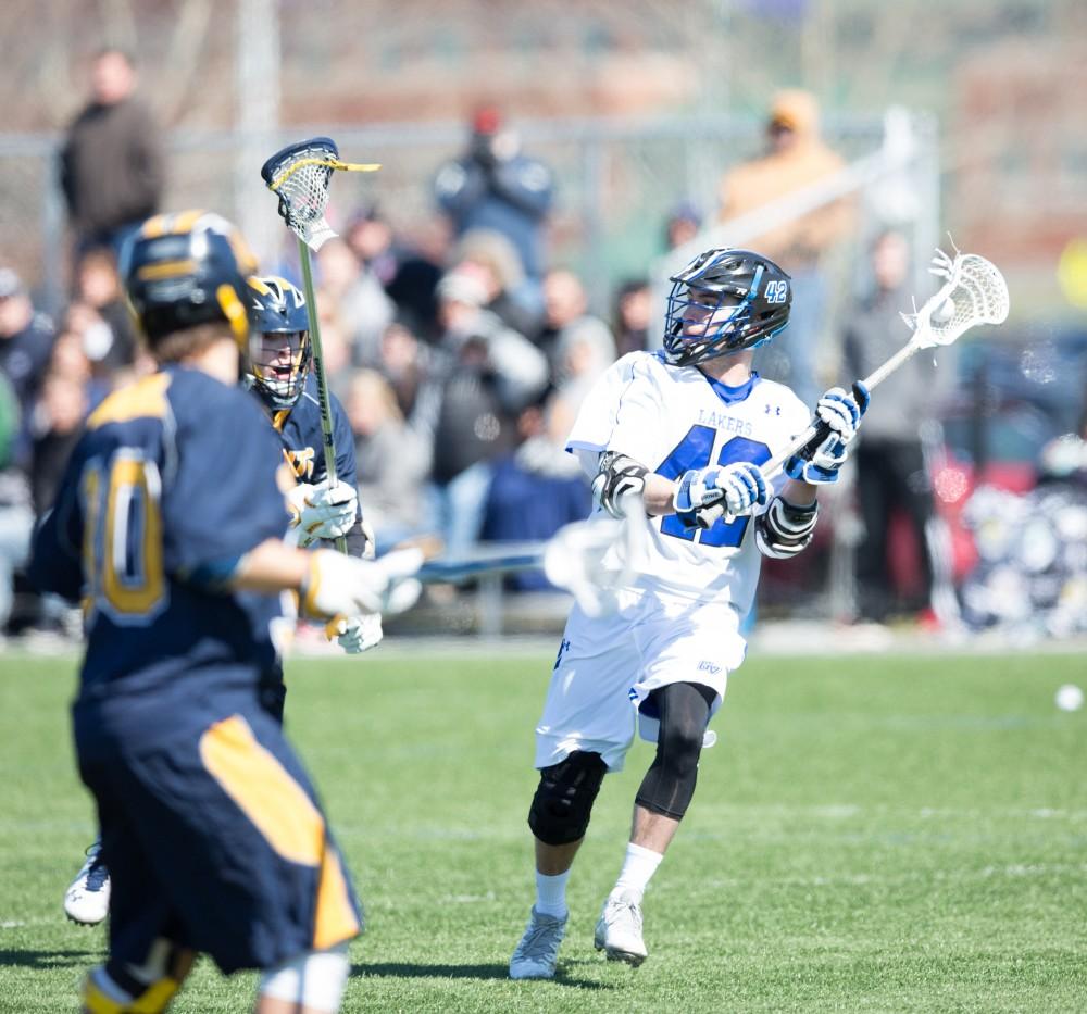 GVL / Kevin Sielaff – Jakob Kippola (42) winds up to launch a pass across the field. Grand Valley’s men’s lacrosse team squares off against Siena Heights University Sunday, March 20, 2016 in Allendale.