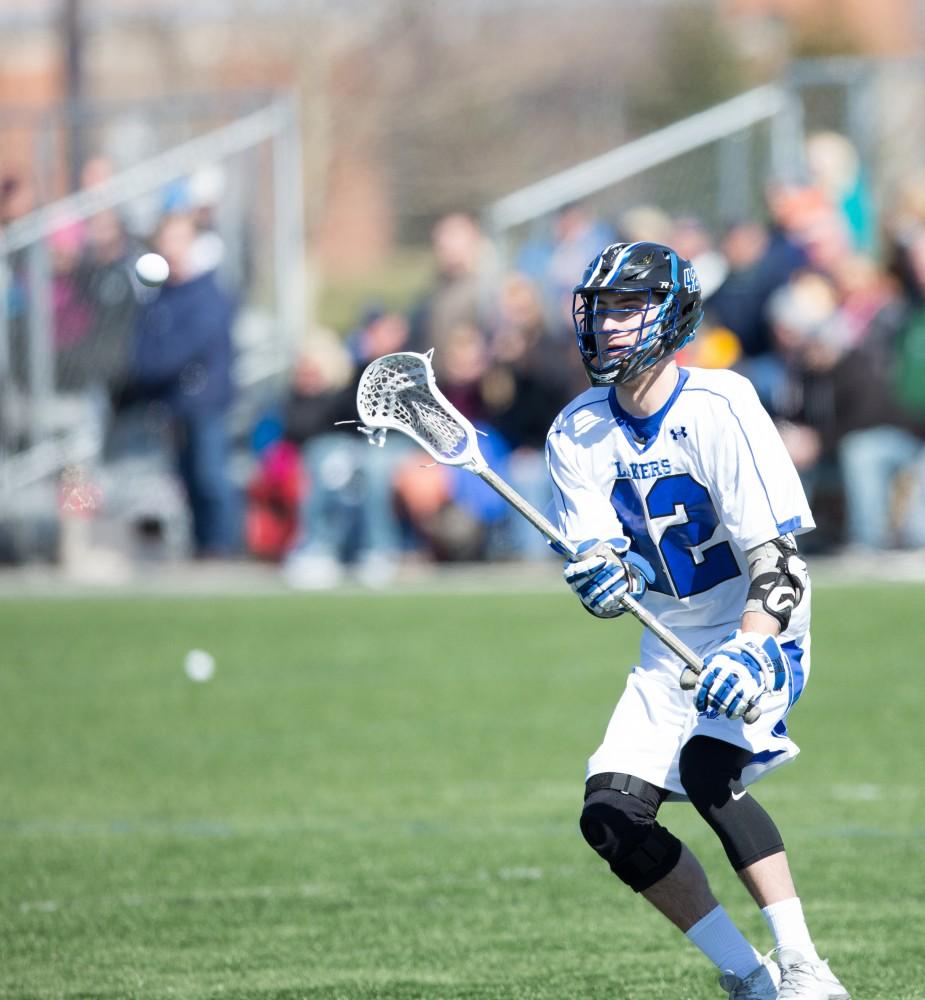 GVL / Kevin Sielaff – Jakob Kippola (42) passes the ball. Grand Valley’s men’s lacrosse team squares off against Siena Heights University Sunday, March 20, 2016 in Allendale.