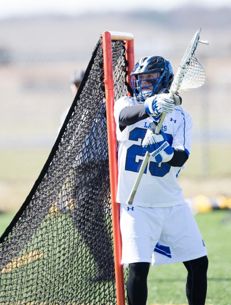 GVL / Kevin Sielaff – Goaltender Kyrn Stoddard (23) calls out to his defensemen. Grand Valley’s men’s lacrosse team squares off against Siena Heights University Sunday, March 20, 2016 in Allendale.