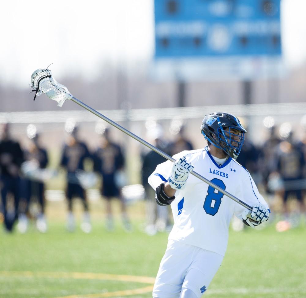 GVL / Kevin Sielaff – Kanto Nakano (8) carries the ball in Siena's zone.  Grand Valley’s men’s lacrosse team squares off against Siena Heights University Sunday, March 20, 2016 in Allendale.