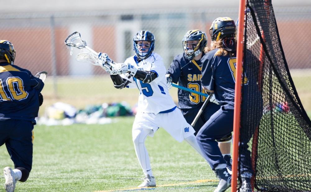 GVL / Kevin Sielaff – Jake Parry (15) winds up for a shot on net. Grand Valley’s men’s lacrosse team squares off against Siena Heights University Sunday, March 20, 2016 in Allendale.