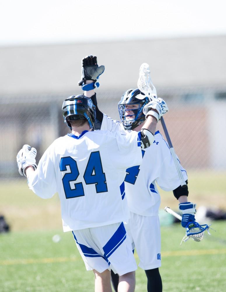 GVL / Kevin Sielaff – Erick Sundstrom (4) celebrates a goal. Grand Valley’s men’s lacrosse team squares off against Siena Heights University Sunday, March 20, 2016 in Allendale.