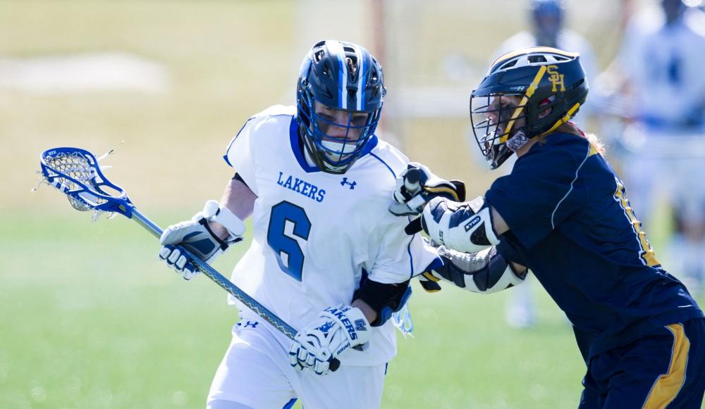 GVL / Kevin Sielaff – Brian Newton (6) pushes into Siena's zone. Grand Valley’s men’s lacrosse team squares off against Siena Heights University Sunday, March 20, 2016 in Allendale.