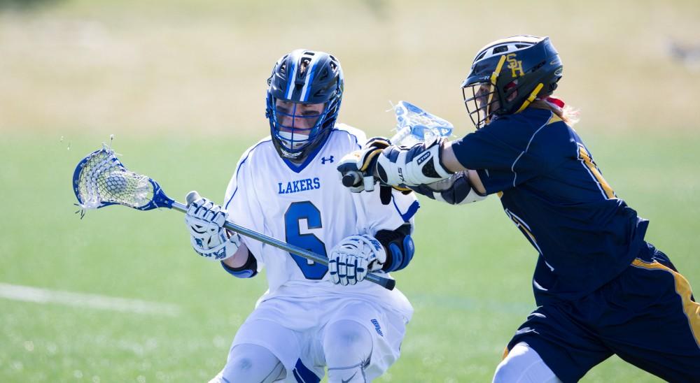 GVL / Kevin Sielaff – Brian Newton (6) pushes into Siena's zone. Grand Valley’s men’s lacrosse team squares off against Siena Heights University Sunday, March 20, 2016 in Allendale.