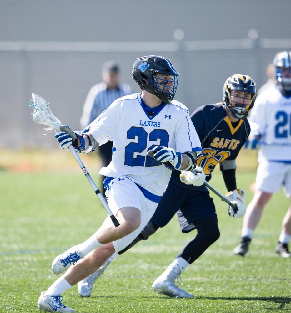 GVL / Kevin Sielaff – Lucas Gerard (22) runs up field with the ball in hand. Grand Valley’s men’s lacrosse team squares off against Siena Heights University Sunday, March 20, 2016 in Allendale.