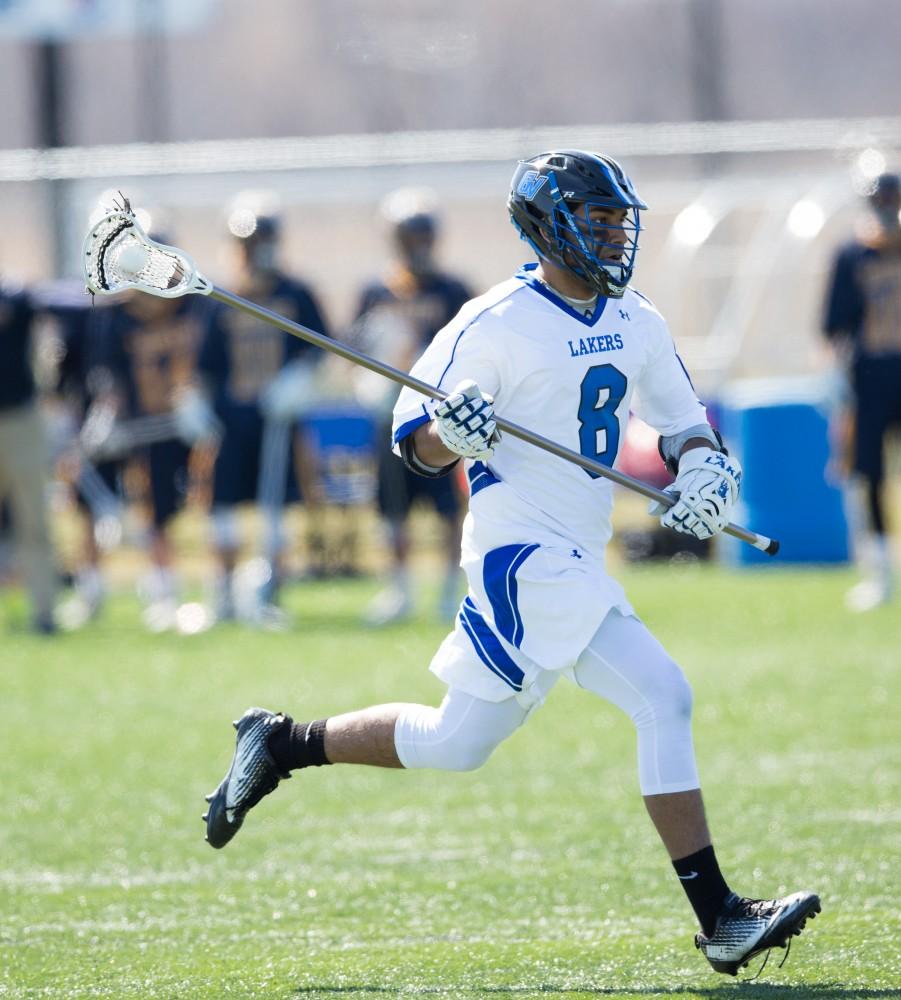 GVL / Kevin Sielaff – Kanto Nakano (8) moves up field with the ball. Grand Valley’s men’s lacrosse team squares off against Siena Heights University Sunday, March 20, 2016 in Allendale.