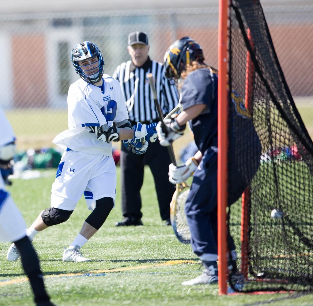 GVL / Kevin Sielaff – Jakob Kippola (42) tries a shot on net and scores. Grand Valley’s men’s lacrosse team squares off against Siena Heights University Sunday, March 20, 2016 in Allendale.