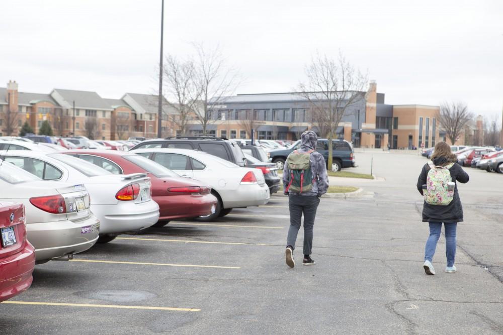 GVL / Sara Carte - Alison Farnsworth and Dan Schrager leave their cars in Lot H on Allendale’s campus on Monday, Mar. 28, 2016.