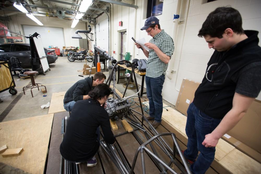 GVL / Kevin Sielaff – Members of Grand Valley’s Formula SAE Racing Team preps the engine to be mounted on the frame of the vehicle inside of the Eberhard Center’s engineering labs Thursday, March 17, 2016.