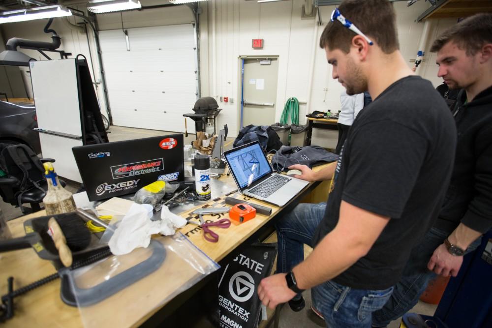 GVL / Kevin Sielaff – Members of Grand Valley’s Formula SAE Racing Team preps the engine to be mounted on the frame of the vehicle inside of the Eberhard Center’s engineering labs Thursday, March 17, 2016.