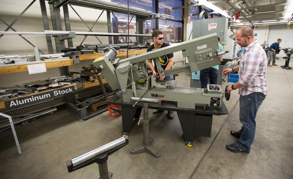 GVL / Kevin Sielaff – Members of Grand Valley’s Formula SAE Racing Team work on push-rod plugs for the vehicle’s suspension, as well as a-arm brackets inside of the Eberhard Center’s engineering labs Thursday, March 17, 2016.