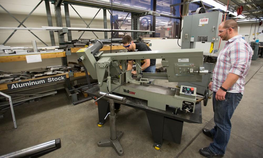 GVL / Kevin Sielaff – Members of Grand Valley’s Formula SAE Racing Team work on push-rod plugs for the vehicle’s suspension, as well as a-arm brackets inside of the Eberhard Center’s engineering labs Thursday, March 17, 2016.