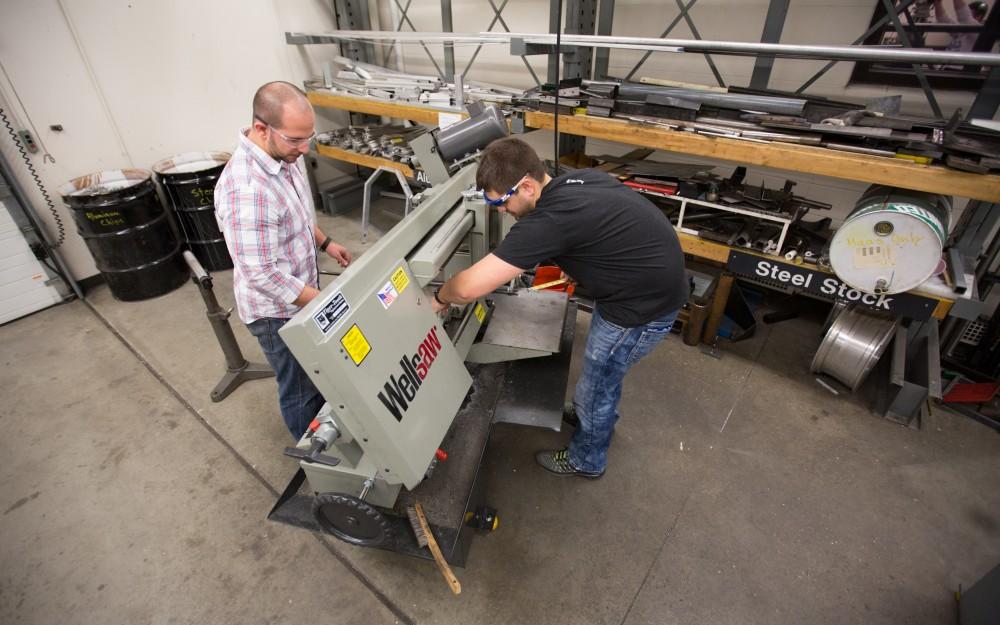 GVL / Kevin Sielaff – Members of Grand Valley’s Formula SAE Racing Team work on push-rod plugs for the vehicle’s suspension, as well as a-arm brackets inside of the Eberhard Center’s engineering labs Thursday, March 17, 2016.