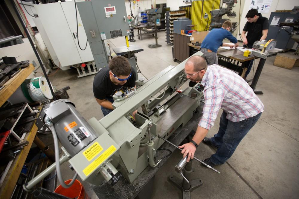 GVL / Kevin Sielaff – Members of Grand Valley’s Formula SAE Racing Team work on push-rod plugs for the vehicle’s suspension, as well as a-arm brackets inside of the Eberhard Center’s engineering labs Thursday, March 17, 2016.