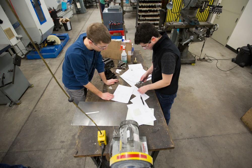 GVL / Kevin Sielaff – Members of Grand Valley’s Formula SAE Racing Team work on push-rod plugs for the vehicle’s suspension, as well as a-arm brackets inside of the Eberhard Center’s engineering labs Thursday, March 17, 2016.