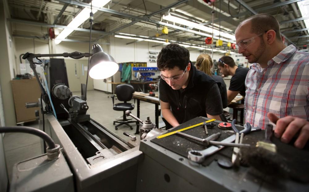 GVL / Kevin Sielaff – Members of Grand Valley’s Formula SAE Racing Team work on push-rod plugs for the vehicle’s suspension, as well as a-arm brackets inside of the Eberhard Center’s engineering labs Thursday, March 17, 2016.