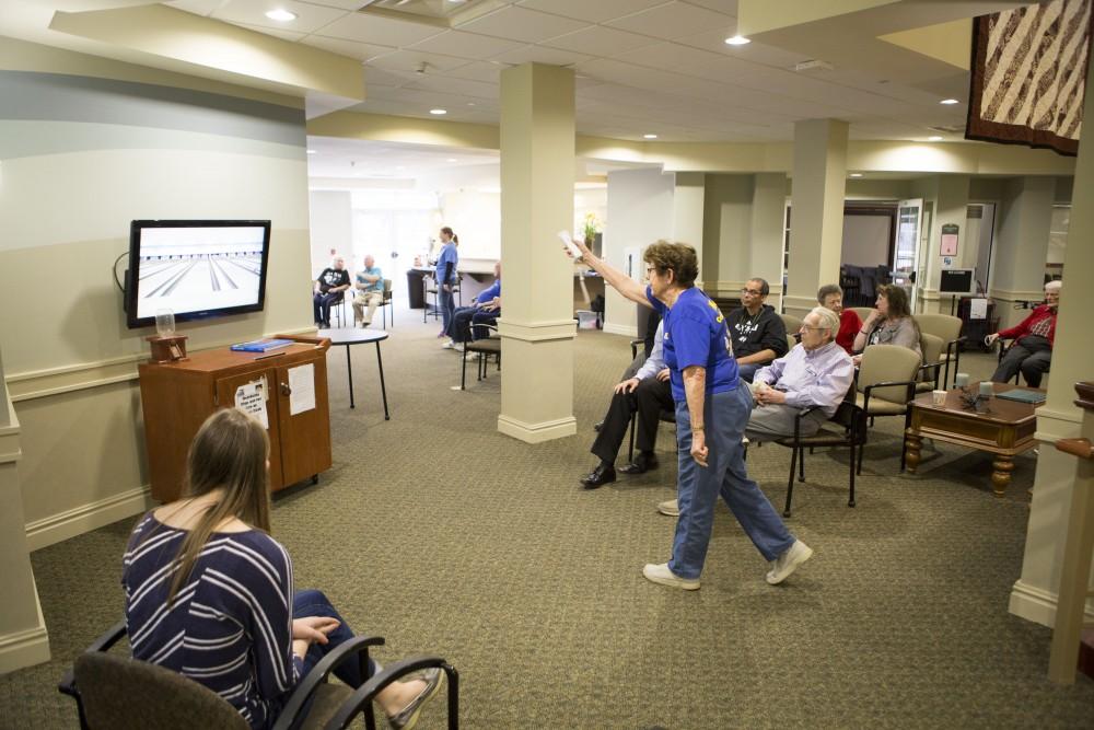 GVL / Sara Carte - Volunteers play in the wii bowling tournament for Community Outreach Week at the Covenant Village of the Great Lakes on Thursday, Mar. 24, 2016.