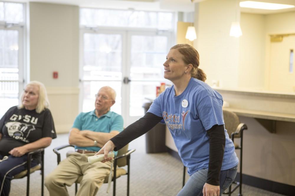 GVL / Sara Carte - Volunteer, Tracey Lewis, plays in the wii bowling tournament for Community Outreach Week at the Covenant Village of the Great Lakes on Thursday, Mar. 24, 2016.