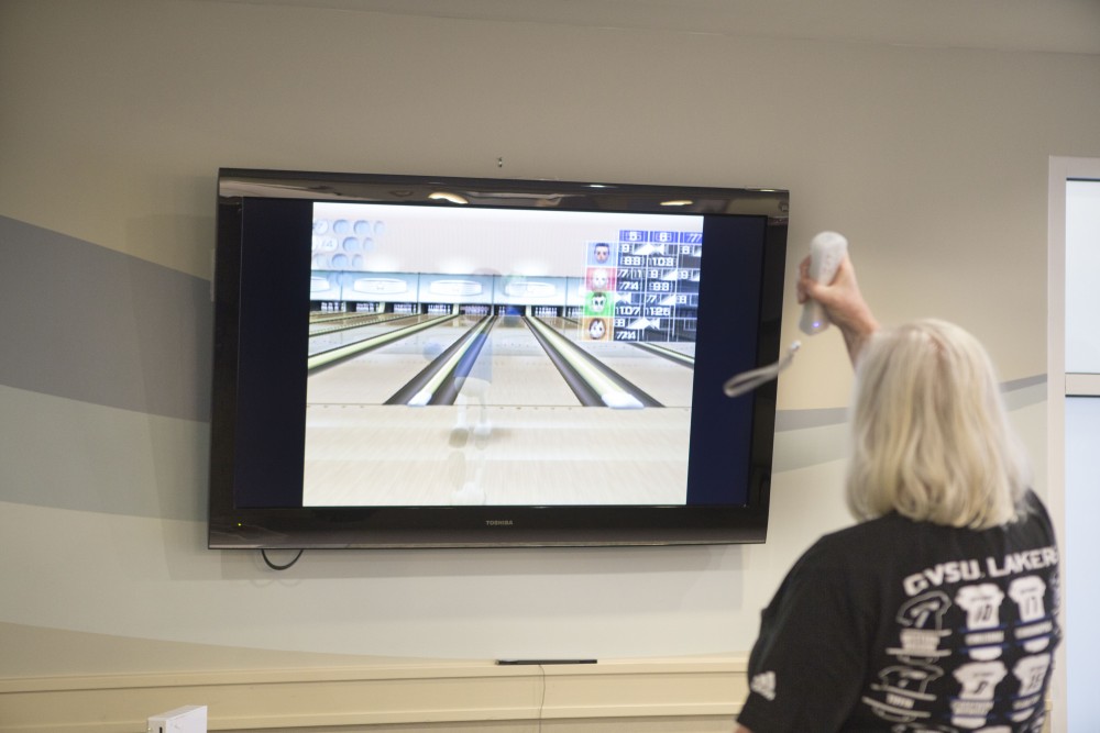 GVL / Sara Carte - Volunteer, Willma Vanderzwaag, plays in the wii bowling tournament for Community Outreach Week at the Covenant Village of the Great Lakes on Thursday, Mar. 24, 2016.