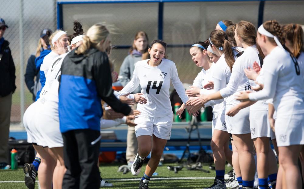 GVL / Kevin Sielaff – Chloe Zdybel (14) runs onto the field as the starting line-up is announced. The Lakers defeat the Greyhounds of the University of Indianapolis Saturday, March 26, 2016 with a final score of 15-4.