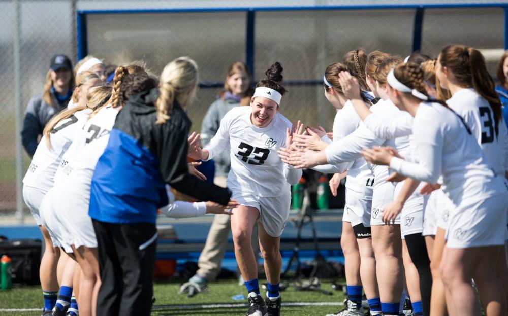 GVL / Kevin Sielaff – Caitlin Wojichowski (33) runs onto the field as the starting line-up is announced. The Lakers defeat the Greyhounds of the University of Indianapolis Saturday, March 26, 2016 with a final score of 15-4.