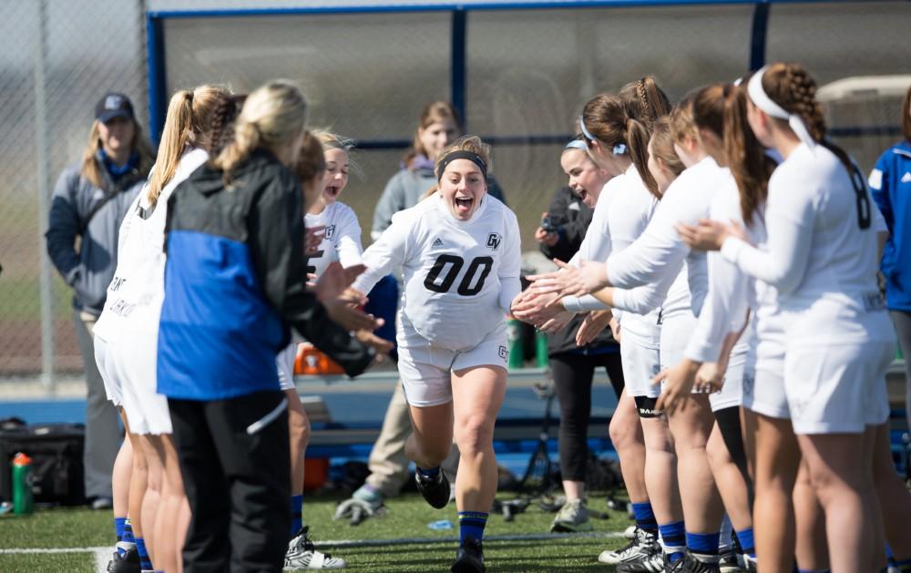 GVL / Kevin Sielaff – Sarah Zwilsky (00) runs onto the field as the starting line-up is announced. The Lakers defeat the Greyhounds of the University of Indianapolis Saturday, March 26, 2016 with a final score of 15-4.