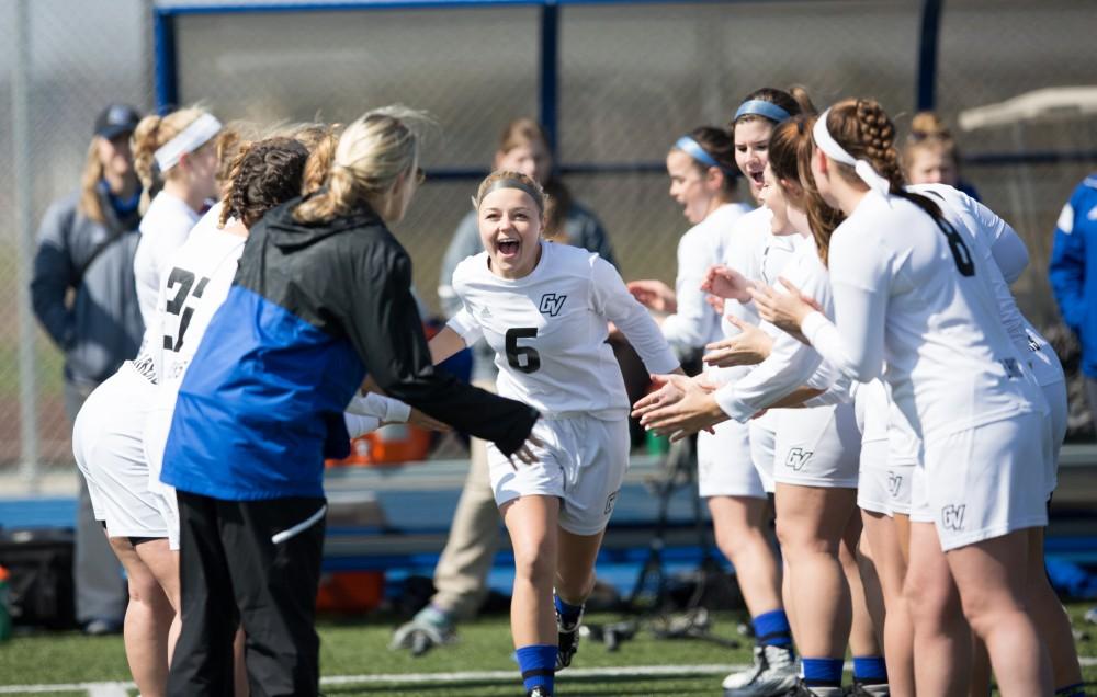 GVL / Kevin Sielaff – Ashley Bailey (6) runs onto the field as the starting line-up is announced. The Lakers defeat the Greyhounds of the University of Indianapolis Saturday, March 26, 2016 with a final score of 15-4.