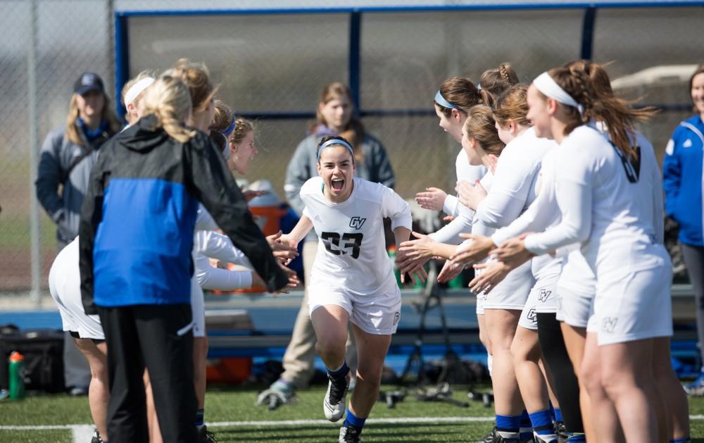 GVL / Kevin Sielaff – Carolyn Kruas (23) runs onto the field as the starting line-up is announced. The Lakers defeat the Greyhounds of the University of Indianapolis Saturday, March 26, 2016 with a final score of 15-4.