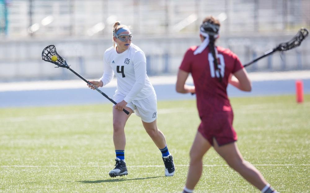 GVL / Kevin Sielaff – Kira Dosenberry (4) looks to pass the ball off as she runs into Indianapolis' zone. The Lakers defeat the Greyhounds of the University of Indianapolis Saturday, March 26, 2016 with a final score of 15-4.