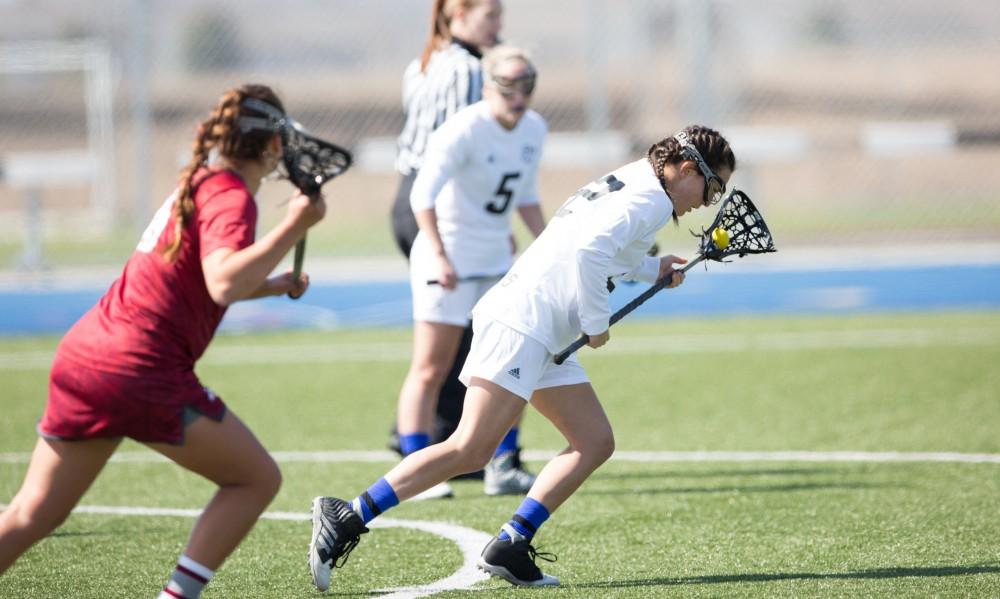 GVL / Kevin Sielaff – Kali heller-Spencer (22) takes off toward Indianapolis' zone from Grand Valley's goal. The Lakers defeat the Greyhounds of the University of Indianapolis Saturday, March 26, 2016 with a final score of 15-4.