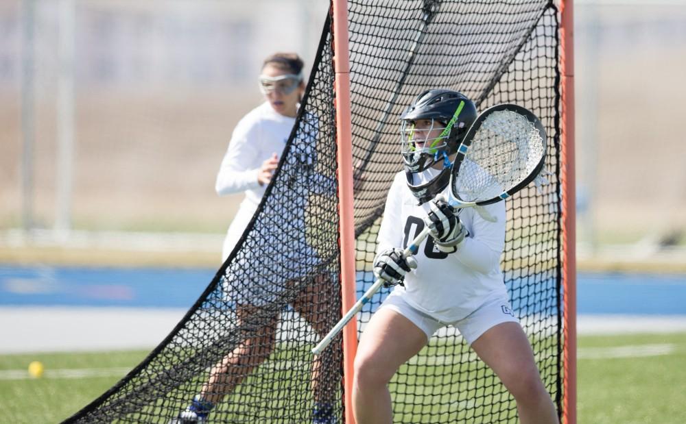 GVL / Kevin Sielaff – Sarah Zwilsky (00) stands ready in goal as the play moves toward Grand Valley's net. The Lakers defeat the Greyhounds of the University of Indianapolis Saturday, March 26, 2016 with a final score of 15-4.