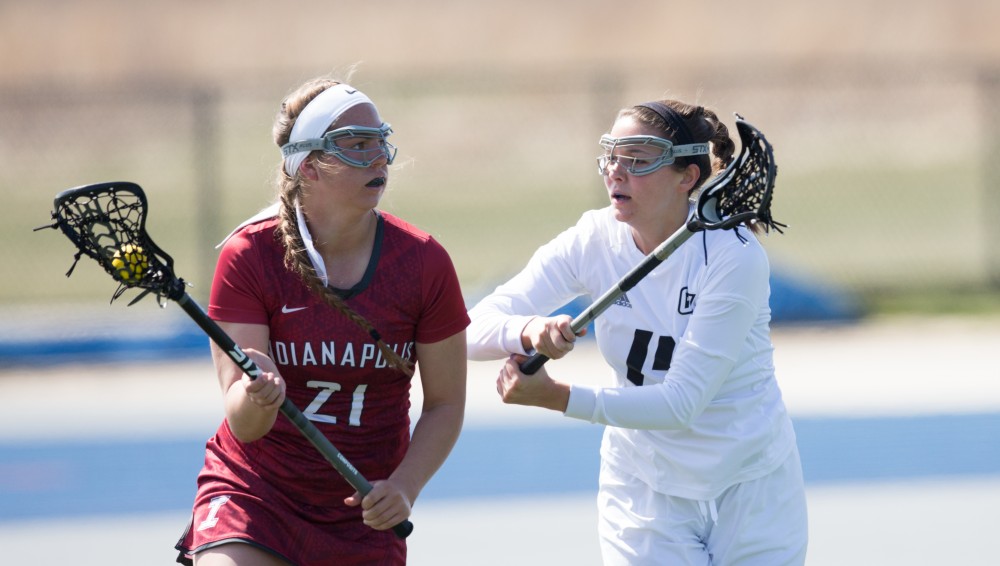 GVL / Kevin Sielaff – Chloe Zdybel (14) defends Sydney Hauffman (21) of Indianapolis. The Lakers defeat the Greyhounds of the University of Indianapolis Saturday, March 26, 2016 with a final score of 15-4.