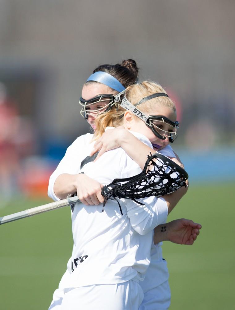 GVL / Kevin Sielaff – Ashley Bailey (6) and Carolyn Kraus (23) celebrate a goal. The Lakers defeat the Greyhounds of the University of Indianapolis Saturday, March 26, 2016 with a final score of 15-4.