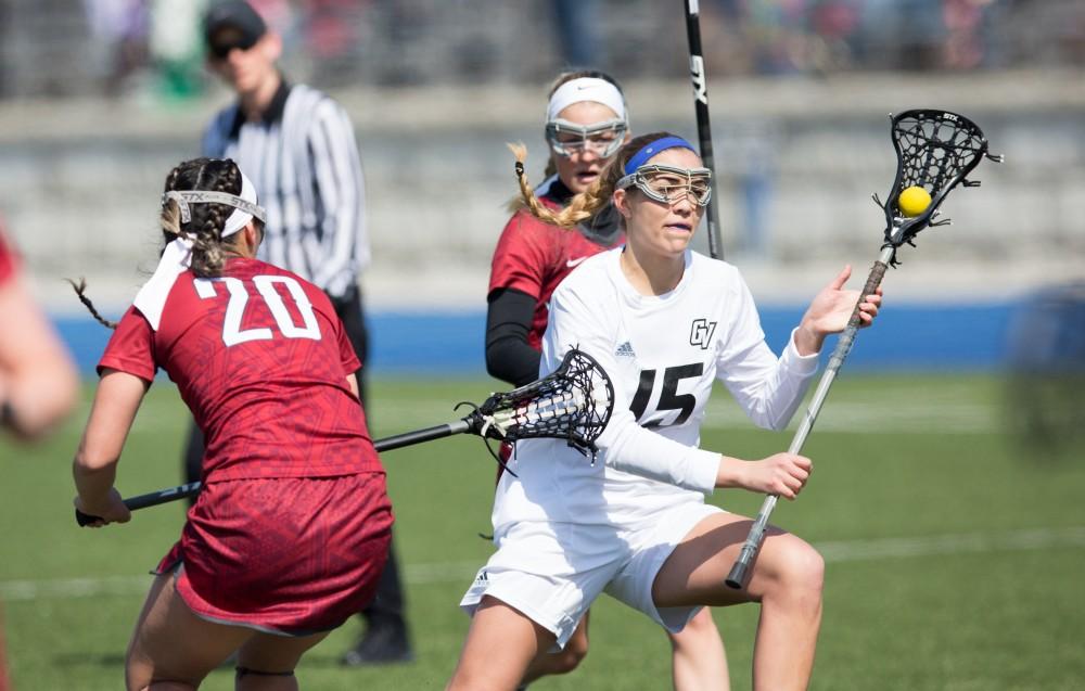 GVL / Kevin Sielaff – Meggan Loyd (15) gets around the Indianapolis defense and moves in to take a shot on net. The Lakers defeat the Greyhounds of the University of Indianapolis Saturday, March 26, 2016 with a final score of 15-4.